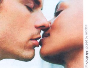 Closely cropped photograph of two people kissing